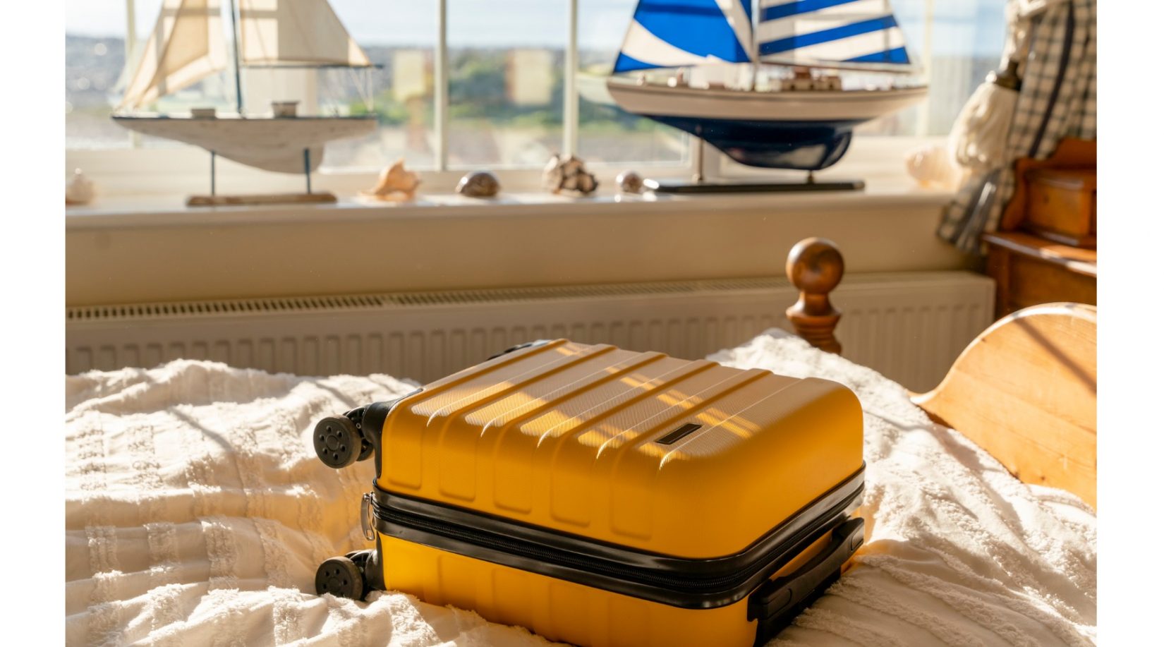 yellow suitcase on a bed
